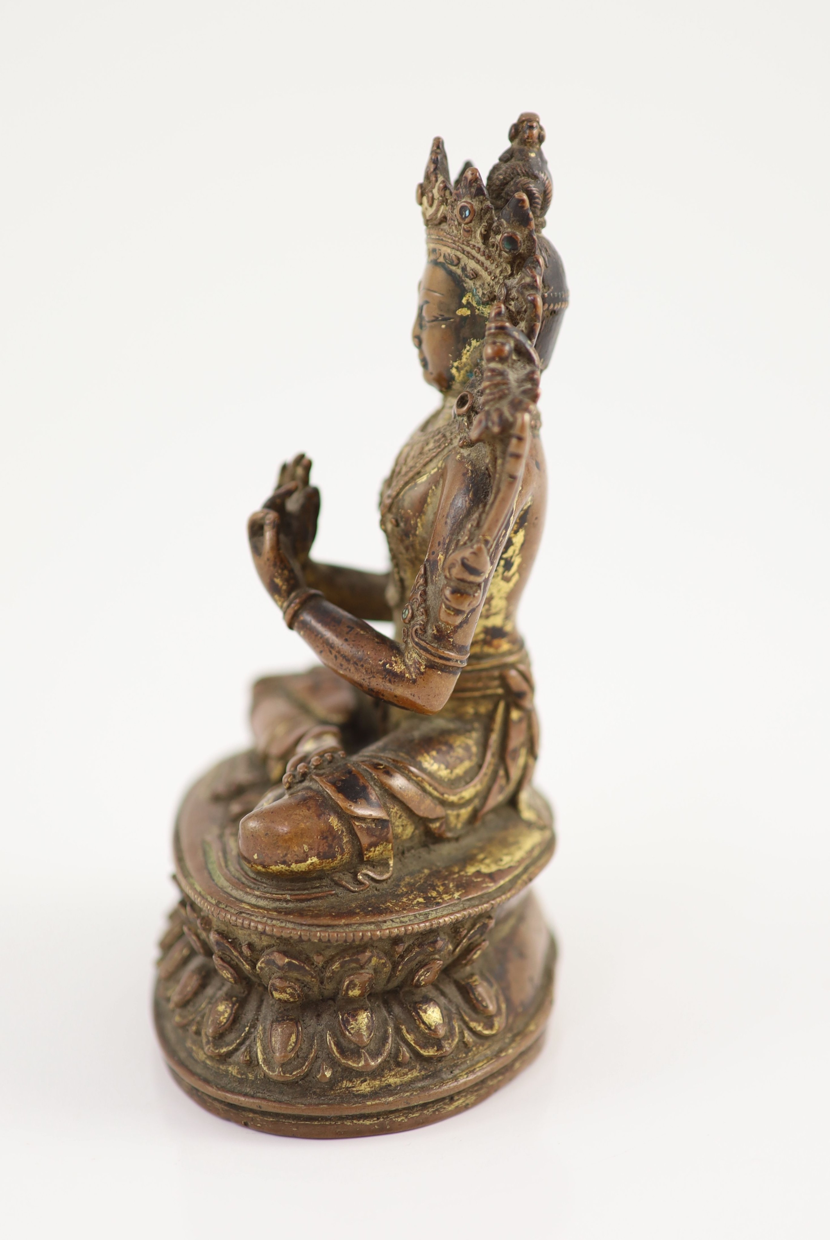 A Tibetan gilt copper alloy figure of Maitreya, 17th/18th century, 14.8cm high, worn